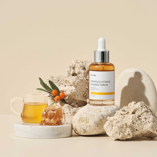IUNIK Propolis Vitamin Synergy Serum (50ml) product image on the serum, with rocks and jug of the serum