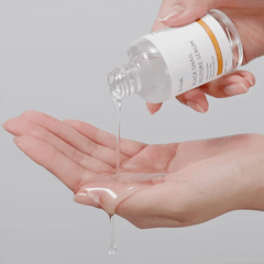 IUNIK Black Snail Restore Serum (50ml) product is being poured into the hand showing the texture